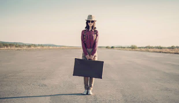 Hipster woman stands on road