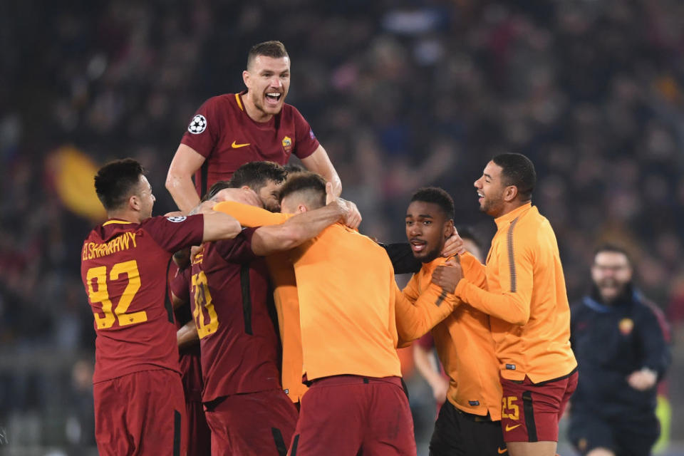 Edin Dzeko ceebrates with his Roma teammates at the Stadio Olimpico in Rome, Italy.