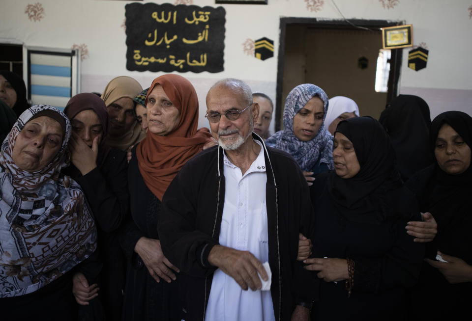 Relatives mourn the death of Palestinian Hamas militant, Mohammad Abu Namous, 27, in the family home during his funeral in the Jabaliya refugee camp, northern Gaza Strip, Sunday, Aug. 18, 2019. Gaza's Health Ministry said Israeli troops killed three Palestinians and severely wounded a fourth near the heavily guarded perimeter fence. The Israeli military said Sunday that a helicopter and a tank fired at a group of armed suspects near the fence overnight. (AP Photo/Khalil Hamra)