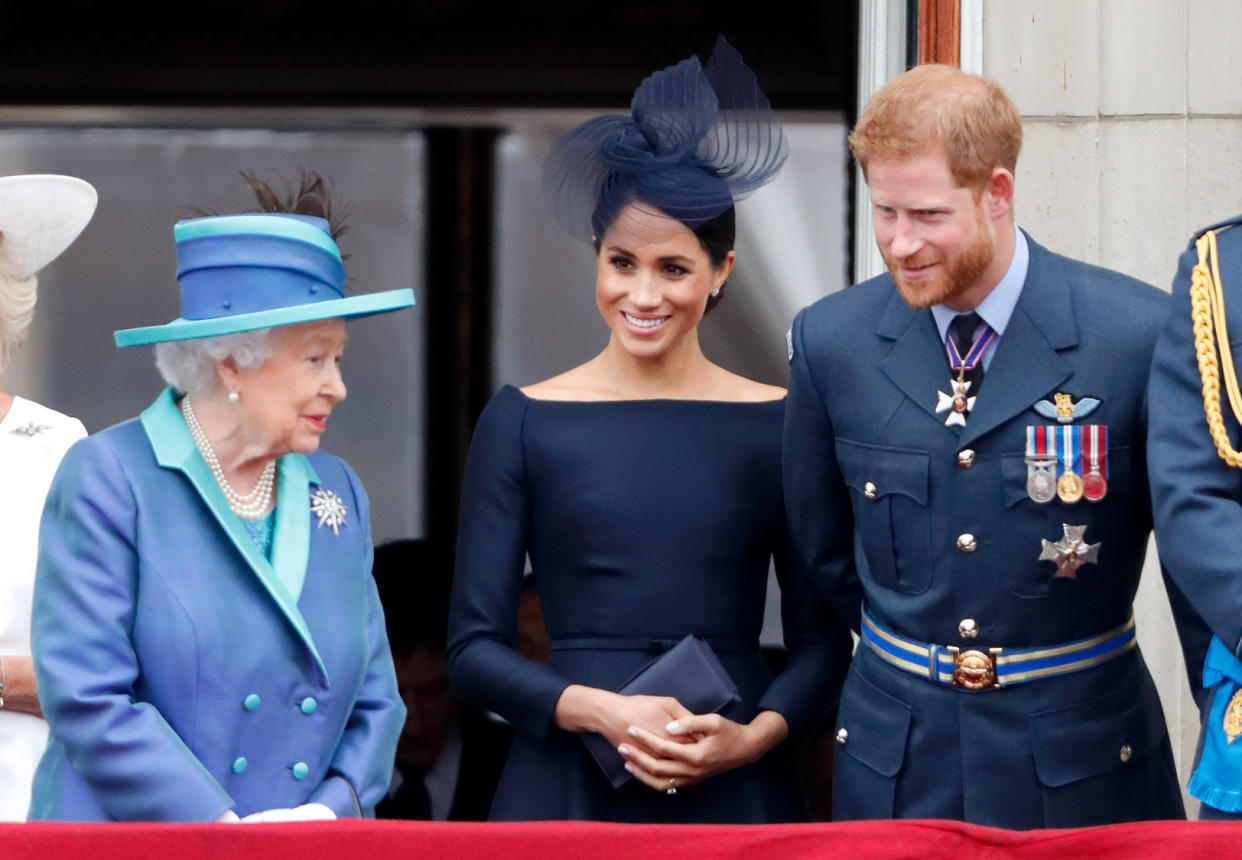 LONDON, UNITED KINGDOM - JULY 10: (EMBARGOED FOR PUBLICATION IN UK NEWSPAPERS UNTIL 24 HOURS AFTER CREATE DATE AND TIME) Queen Elizabeth II, Meghan, Duchess of Sussex and Prince Harry, Duke of Sussex watch a flypast to mark the centenary of the Royal Air Force from the balcony of Buckingham Palace on July 10, 2018 in London, England. The 100th birthday of the RAF, which was founded on on 1 April 1918, was marked with a centenary parade with the presentation of a new Queen's Colour and flypast of 100 aircraft over Buckingham Palace. (Photo by Max Mumby/Indigo/Getty Images)