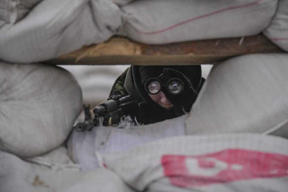 Ukrainian servicemen guard a checkpoint on a main road in Kyiv, Ukraine, Monday, March 7, 2022. (AP Photo/Vadim Ghirda)