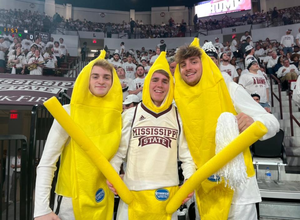Mississippi State basketball fans and MSU students Josh Fisher, Ben Stroud and David Kiesel smile in front of a Humphrey Coliseum crowd before the Bulldogs face Kentucky on Feb. 15, 2023.