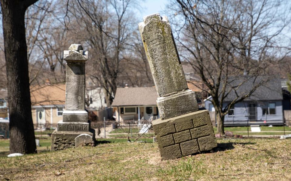 A tombstone leaning on its side sits inside the Oak Grove Burying Ground in Taylor on Wednesday, April 12, 2023. 