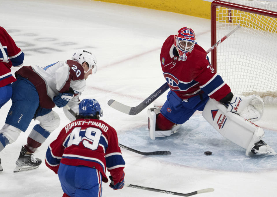 Colorado Avalanche center Ross Colton (20) scores on Montreal Canadiens goaltender Jake Allen (34) during the first period of an NHL hockey game Monday, Jan. 15, 2024, in Montreal. (Ryan Remiorz/The Canadian Press via AP)