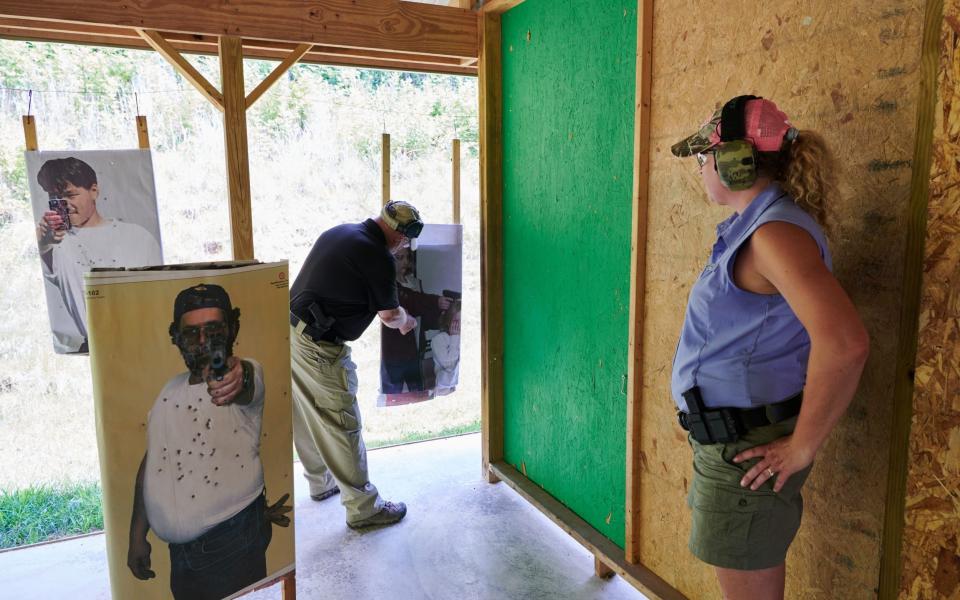 An instructor at the Tactical Defense Institute in West Union, Ohio examines an Ohio teachers marksmanship inside of the Live Fire House. - Stephen Takacs for The Telegraph