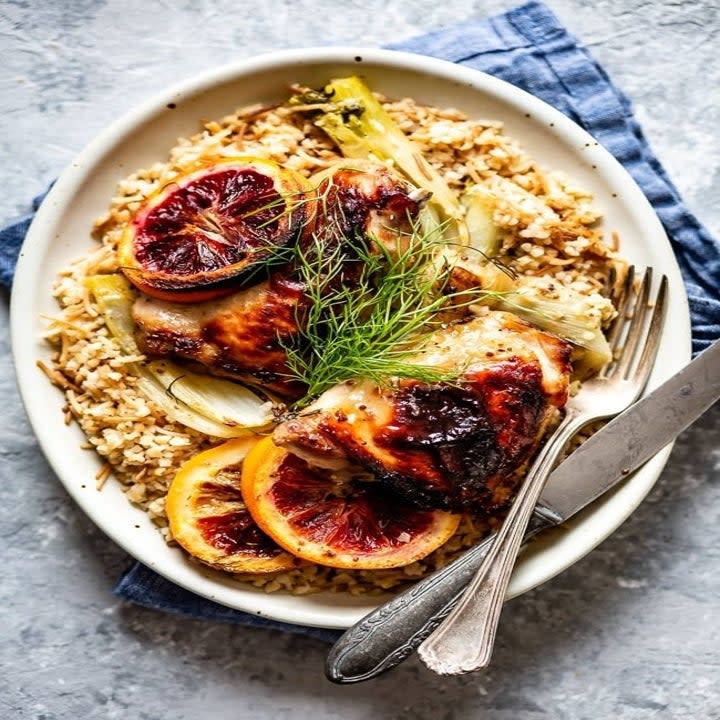 Roasted orange chicken over grains with fennel.