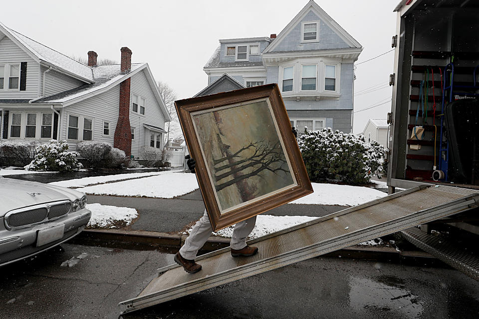 QUINCY, MA - APRIL 2: A piece of artwork belonging to James Pantages is loaded into a truck at his home in Quincy, MA on April 2, 2018. For many years, Pantages spent weekends at area flea markets, art galleries, and auctions scouring for humble treasures hed squirrel away in the ramshackle three-story home he shared with his mother for roughly 60 years. But when his 96-year-old mother entered an assisted living facility earlier this year, Pantages, 69, was finally forced to reckon with what had grown into an unwieldy collection: a sprawling hoard of some 1,200 objects that crowded every inch of their home. Pantages, who retired in 2002 and is now moving into a smaller place, is working with appraiser Peter Smith, who last month began systematically removing and cataloging the collection, a portion of which is slated for sale this September. (Photo by Suzanne Kreiter/The Boston Globe via Getty Images)