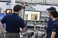 Engineers and workers stand inside Safran Aircraft Engines repair plant outside of Casablanca, Morocco, Thursday, April 18, 2024. Moroccan officials are aiming to turn the country into an aerospace hub, luring investors and manufacturers who have aimed to spread out their supply chains and find willing workers since the COVID-19 pandemic. (AP Photo)