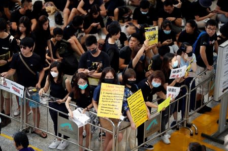 Anti-extradition bill demonstrators attend a protest at the arrival hall of Hong Kong Airport