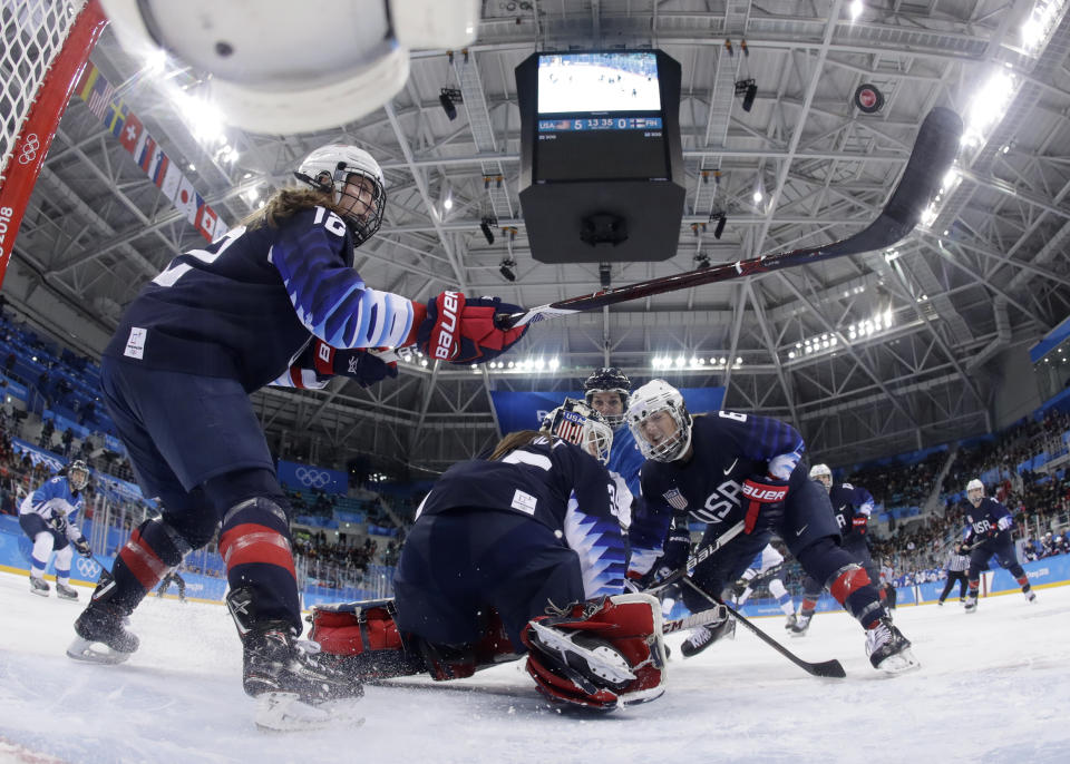 <p>Kelly Pannek (12), of the United States, tries to hit the puck during the third period of the semifinal round of the women’s hockey game against Finland at the 2018 Winter Olympics in Gangneung, South Korea, Monday, Feb. 19, 2018. (Matt Slocum/Pool Photo via AP) </p>