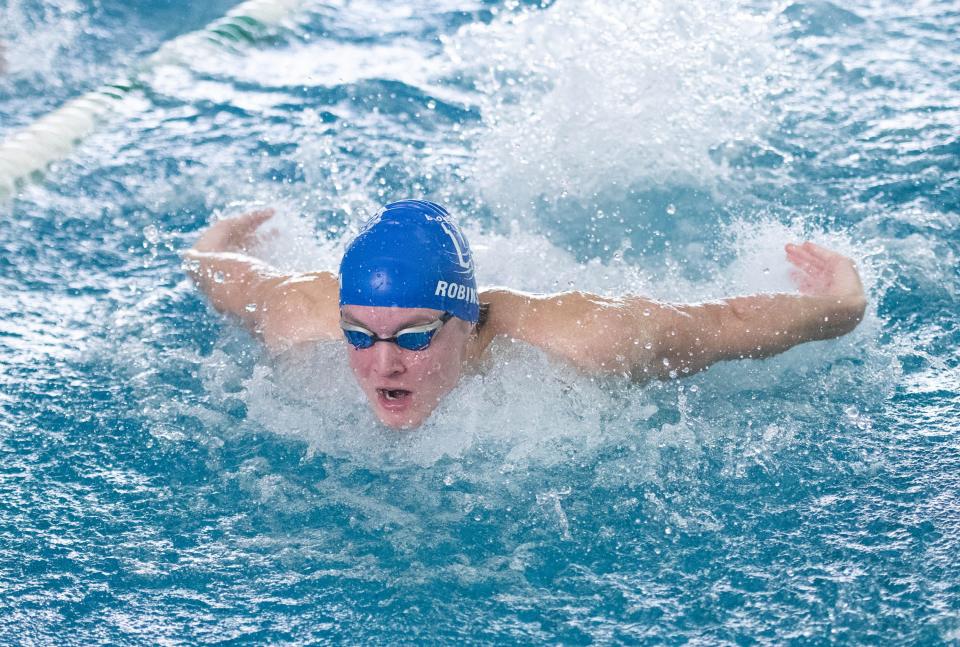 Logan Robinson, of Booker T. Washington High School, competes in the Boys 100 Yard Butterfly during the 3A District 1 Championship swim meet at the University of West Florida in Pensacola on Friday, Oct. 27, 2023.
