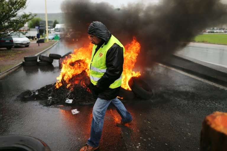 Demonstrators block a road in Saint-Etienne-du-Rouvray, northwestern France, on May 31, 2016 as protests continue across the country