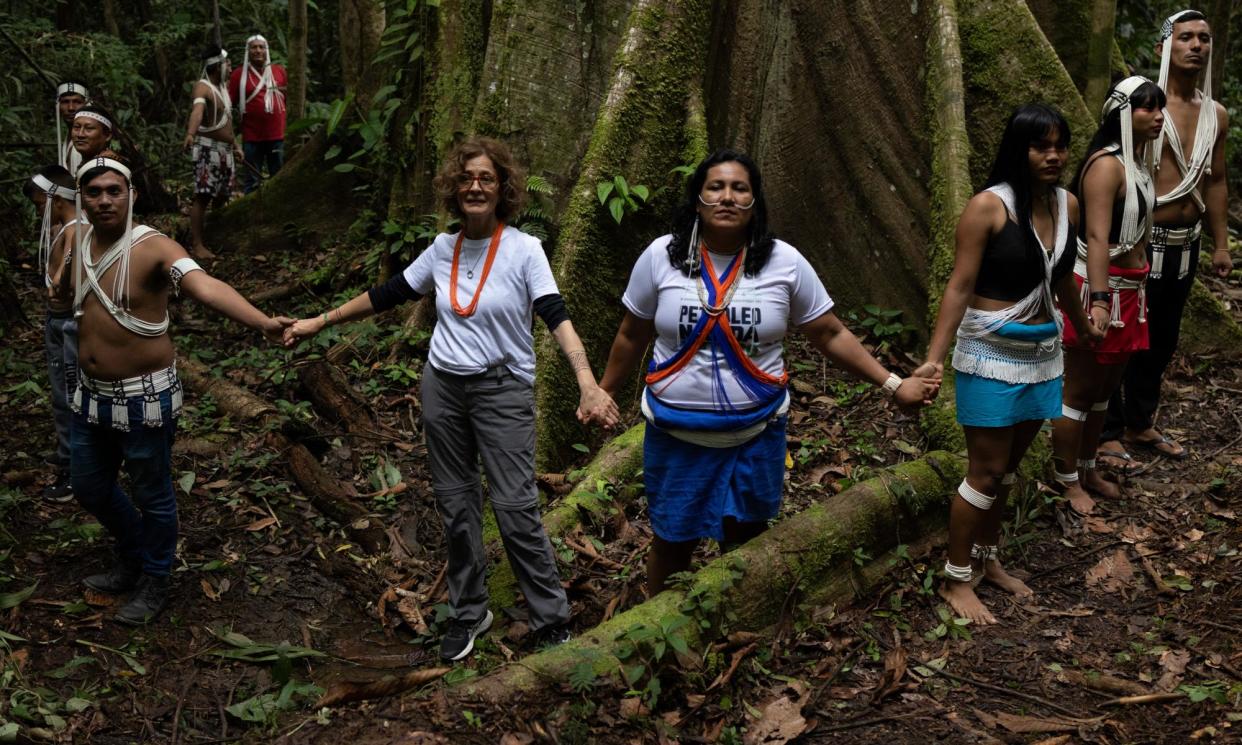 <span>Dom Phillips’ widow Alessandra Sampaio joins hands with members of the Matis and Marubo peoples around a kapok tree during a visit to Indigenous communities.</span><span>Photograph: João Laet/The Guardian</span>