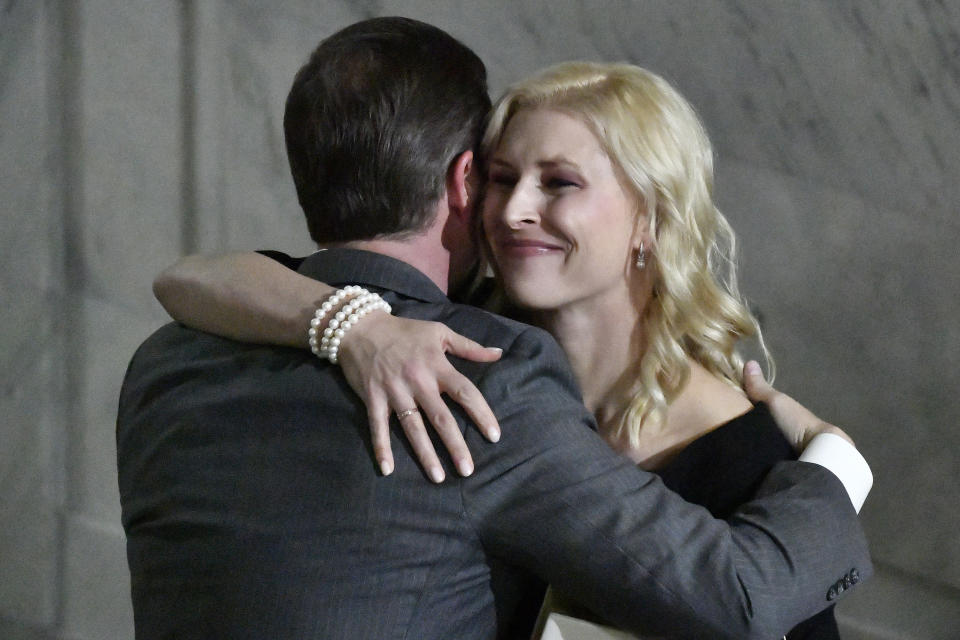 Kentucky first lady Britainy Beshear hugs her husband, Kentucky Gov. Andy Beshear, after he took the oath of office in the Capitol Rotunda in Frankfort, Ky., early Tuesday, Dec. 12, 2023. (AP Photo/Timothy D. Easley)