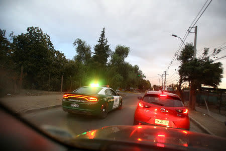 A police vehicle travels along a road after a magnitude 7.1 earthquake hit off the coast in Santiago, Chile April 24, 2017 REUTERS/Ivan Alvarado