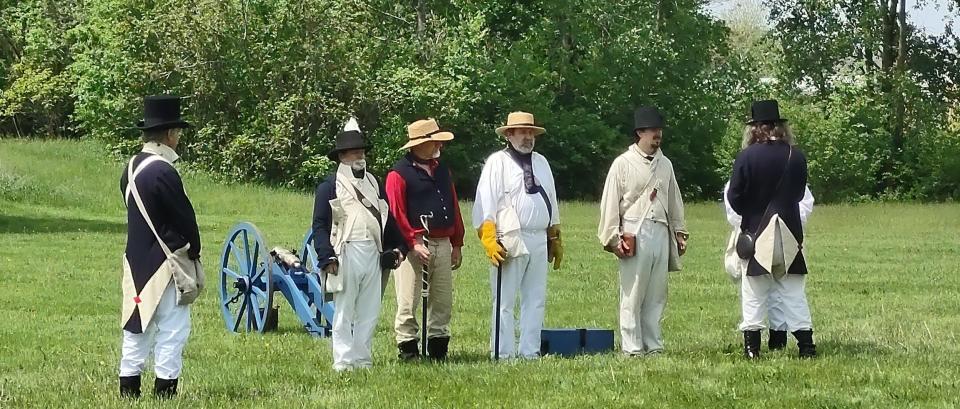 A group of re-enactors perform a drill.