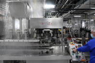 Foreman Dave Garthe runs boiling water through and over machinery in preparation for Hanan Products kosher-for-passover production run, Thursday, Jan. 7, 2021, in Hicksville, N.Y. At Hanan Products, which since 1946 has made primarily whipped toppings, icings and dessert fillings for the bakery industry, cleaning and production for kosher-for-Passover products begin long before the weeklong holiday that this year starts in late March. (AP Photo/Seth Wenig)