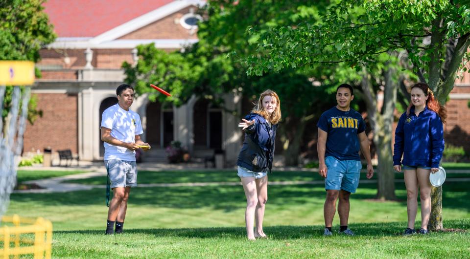 Siena Heights University students try out the university's disc golf course Friday. It opened to students and the public in the fall of 2022. The course has 12 holes spread throughout the main campus in Adrian.