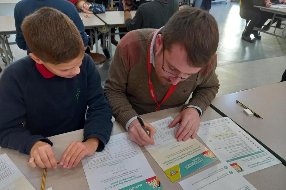 Kingsmead year six pupil Joseph Wilshaw helps Guardian reporter Rob Goulding mark his test paper <i>(Image: Rob Goulding)</i>