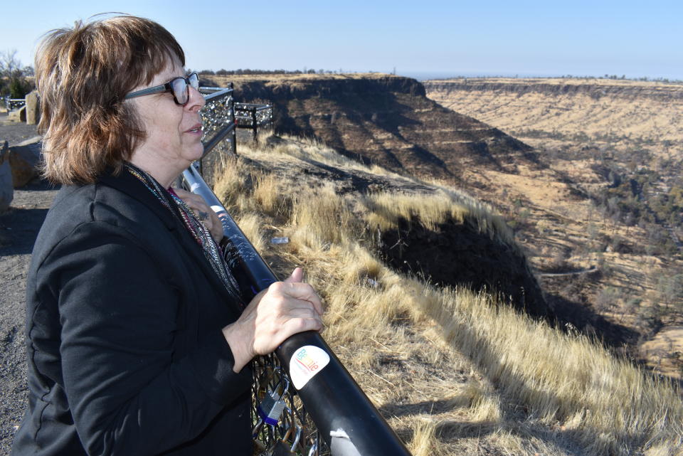 In this Friday, Nov. 22, 2019, photo, Elizabeth Watling looks over Butte Creek Canyon, which was burned in a 2018 wildfire that destroyed the nearby town of Paradise, Calif. Watling is participating in a University of California, Davis study of the health impacts of inhaling smoke from the fire that killed 85 people and destroyed more than 14,000 homes. (AP Photo/Matthew Brown)