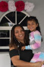 Temporary Protected Status (TPS) holder Lili Montalvan, left, of El Salvador, poses for a photo with her daughter Roxana Gozzer, 6, Sunday, Oct. 25, 2020, at their home in Fort Lauderdale, Fla. (AP Photo/Wilfredo Lee)