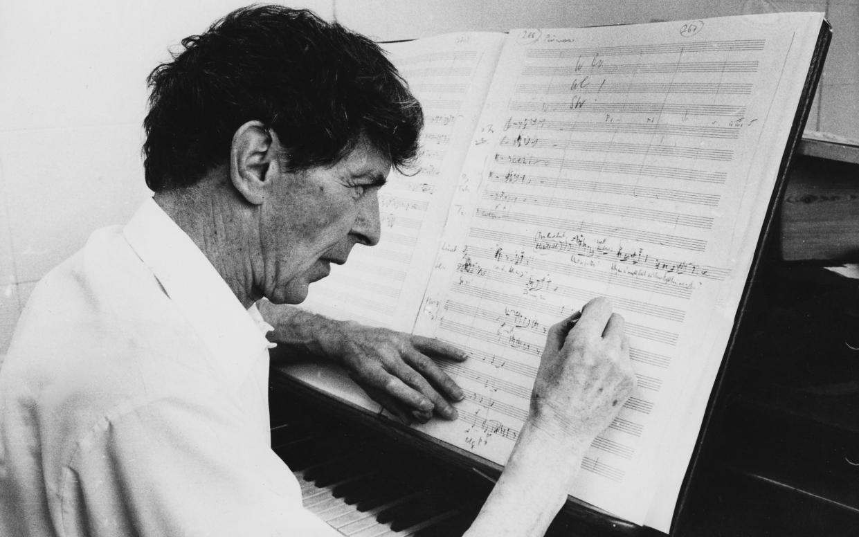Composer Sir Michael Tippett, whose opera The Midsummer Marriage was first performed in 1955, pictured at the piano in 1974 - Radio Times/Getty Images