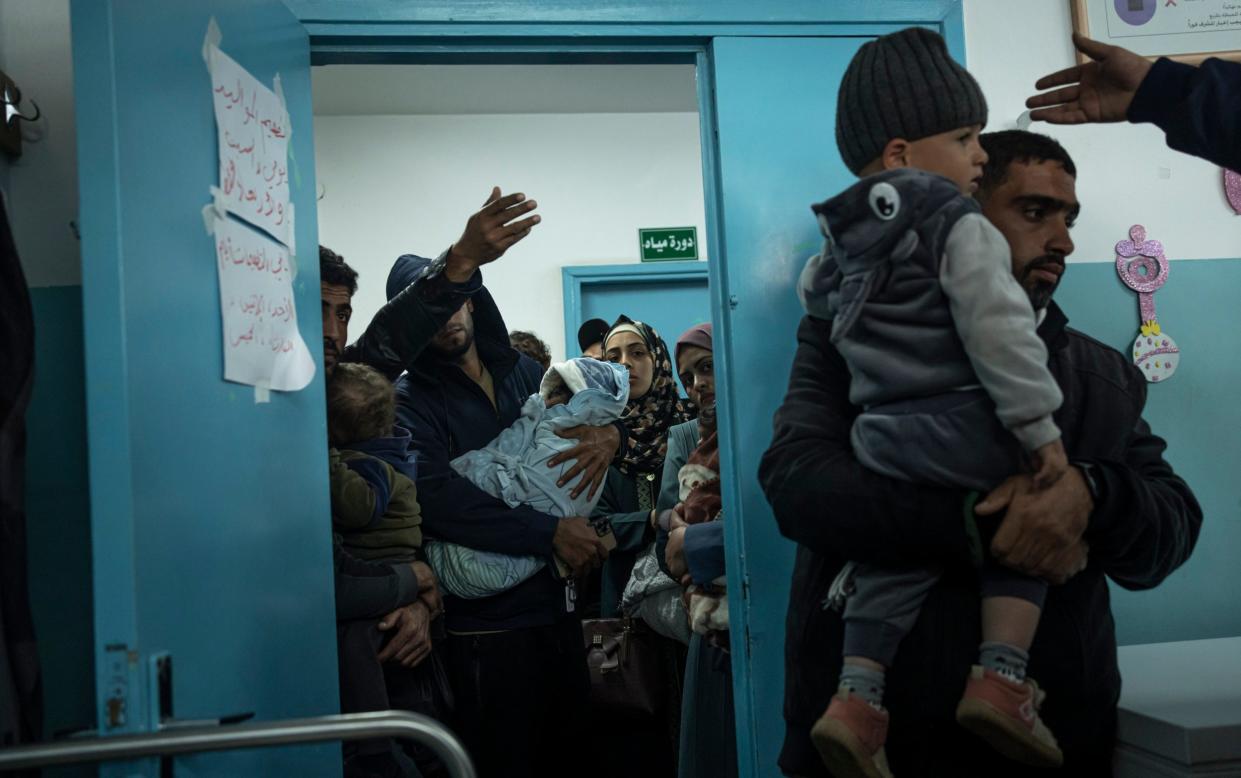 Palestinians line up with their children to receive vaccination against diseases, which recently entered Gaza as part of aid, in Rafah, southern Gaza Strip