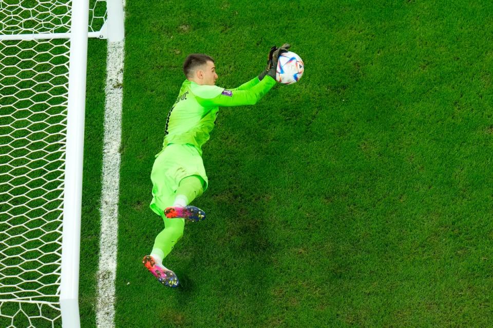 Dominik Livakovic saving a penalty in Croatia’s shootout win over Brazil (Copyright 2022 The Associated Press. All rights reserved)