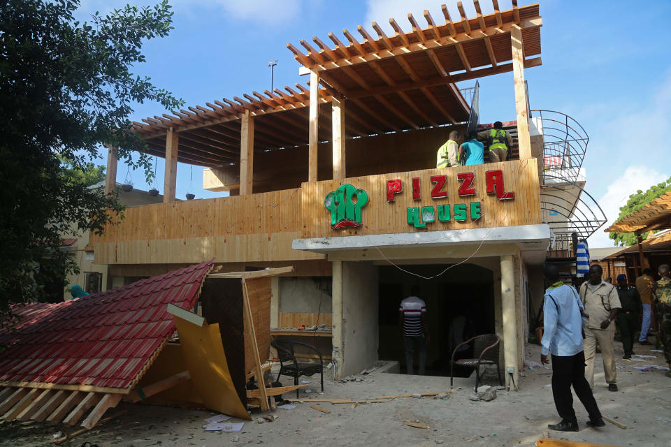 <p>People inspect the site after bomb-laden vehicle attack by Al-Shabaab militants to a restaurant in Mogadishu, Somalia on June 15, 2017. (Photo: Saadaq Maxamed/Anadolu Agency/Getty Images) </p>