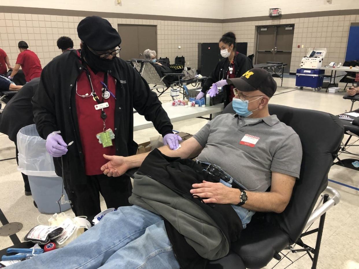 Steve Nash (left), a collection specialist for the American Red Cross, preps the arm of Bruce Vanisacker of Monroe for donating a pint of blood at a Red Cross blood drive held Thursday afternoon at Prince of Peace Lutheran Church, Ida. Vanisacker was donating for the 118th time in his career as a donor.