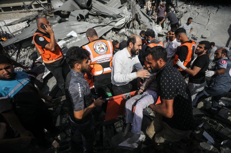 A Palestinian man reacts as the body of his daughter is unearthed from under the rubble after an Israeli strike on on a home in Rafah in southern Gaza Strip on Sunday. Photo by Ismael Mohamad/UPI