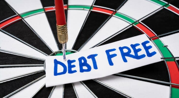 Dart hits the bull's eye of a board labeled "DEBT FREE"