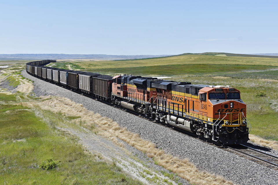 FILE - A BNSF railroad train hauling carloads of coal from the Powder River Basin of Montana and Wyoming is seen east of Hardin, Mont., on July 15, 2020. Roughly 7,500 BNSF train engineers will soon get up to eight days of paid sick time and more predictable schedules if they approve a deal with the railroad that was announced Tuesday, Aug. 1, 2023. (AP Photo/Matthew Brown, File)
