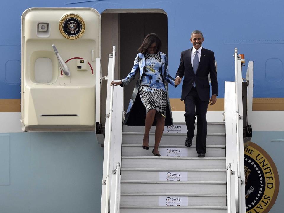 Barack and Michelle Obama exit Air Force One.