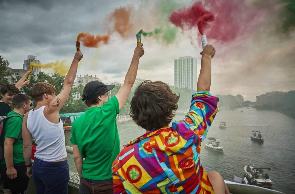 <p>Flayers in the colours of the rainbow flag are sprayed to celebrate unofficial Gay Pride on the banks and in the water of the Canal de l'Ourcq.</p>