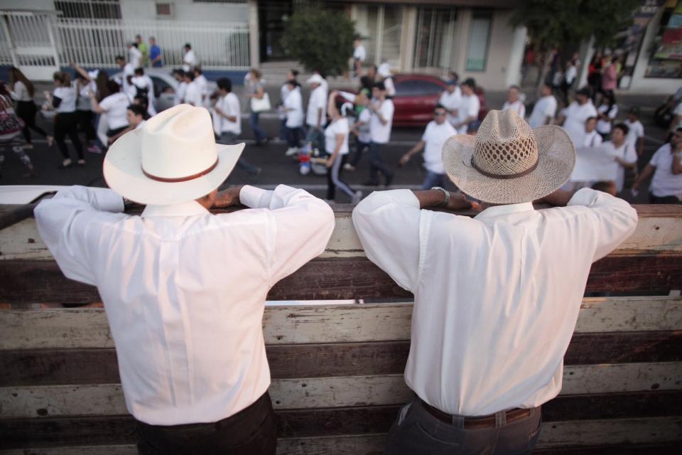 Men observe a march in Culiacan