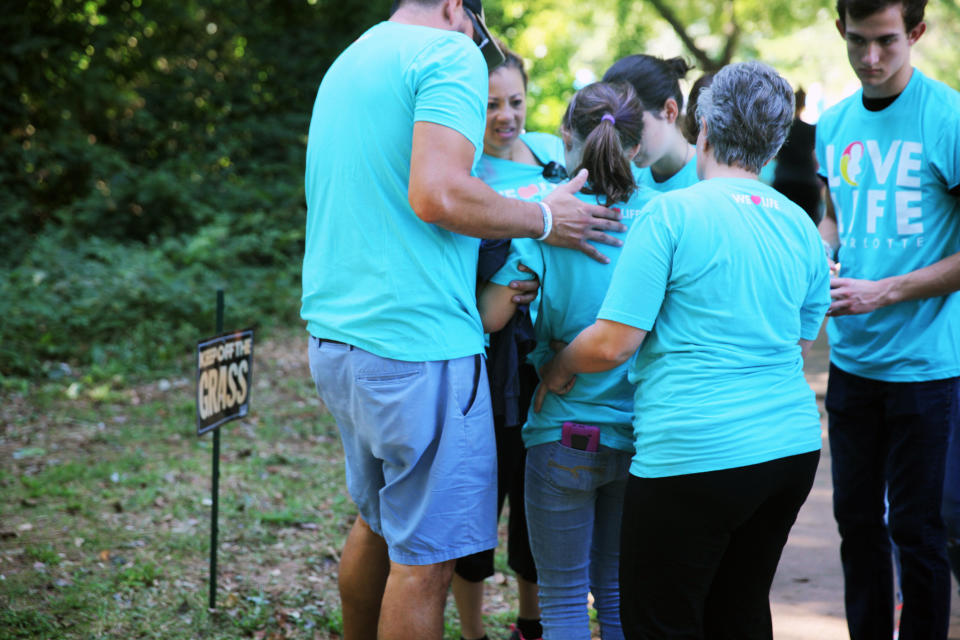 A young member of Love Life Charlotte&nbsp;tries to stand up after suffering dehydration and heat exhaustion on Saturday.