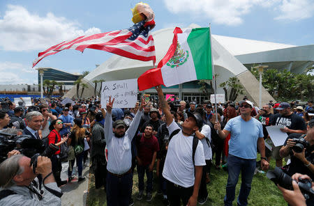 Anti-Trump demonstrators protests outdoors before U.S. Republican presidential candidate Donald Trump speaks at a campaign event in Anaheim, California, U.S., May 25, 2016. REUTERS/Mike Blake