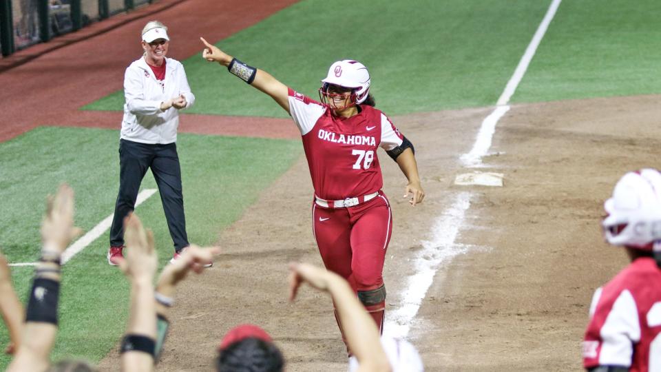 OU coach Patty Gasso (left) claps as slugger Jocelyn Alo (78) heads to home plate on March 11 after hitting her 96th career home run in the Sooners' 11-0 win at Hawaii.