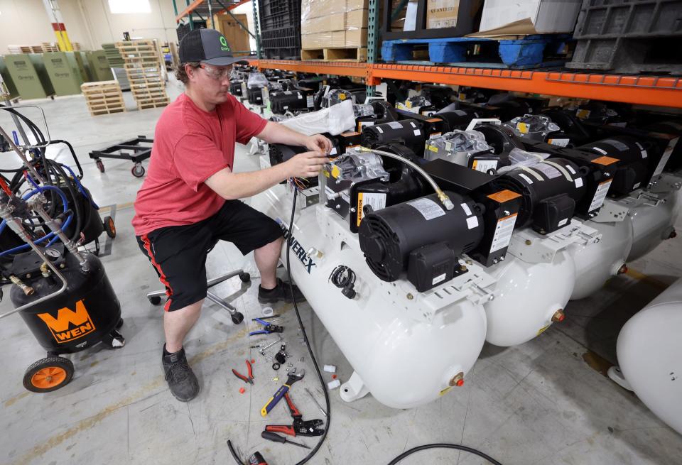 Qnergy production associate Adam Wright wires compressors on a Powerex tank at Qnergy in Ogden on Thursday, May 25, 2023. | Kristin Murphy, Deseret News