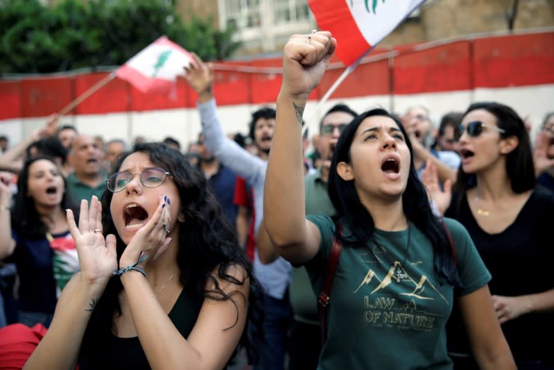 FILE PHOTO: Protesters chant slogans as as they demonstrate outside Lebanon's central bank during ongoing anti-government protests in Beirut