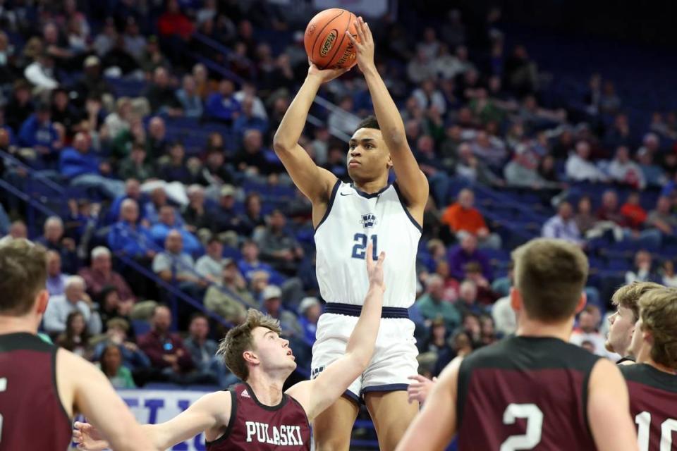 Warren Central’s Chappelle Whitney (21) shoots over the Pulaski County defense during the Dragons’ first-round victory on Wednesday in Rupp Arena.