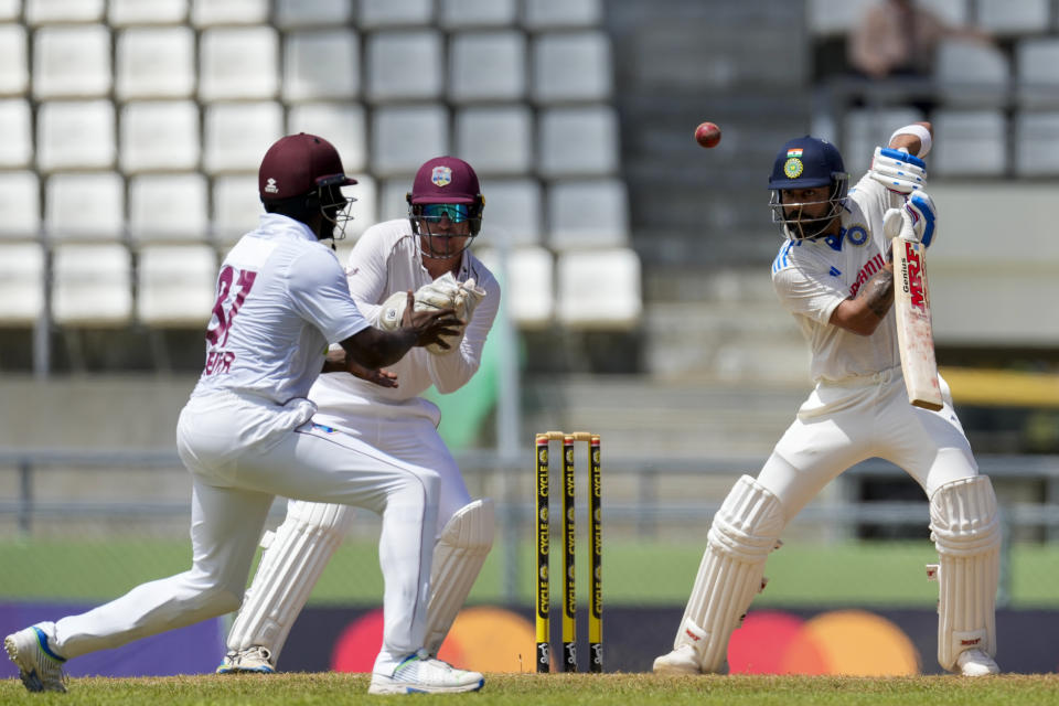 West Indies' fielders eye the ball as India's Virat Kohli plays a shot from the bowling of Jomel Warrican on day three of their first cricket Test match at Windsor Park in Roseau, Dominica, Friday, July 14, 2023. (AP Photo/Ricardo Mazalan)