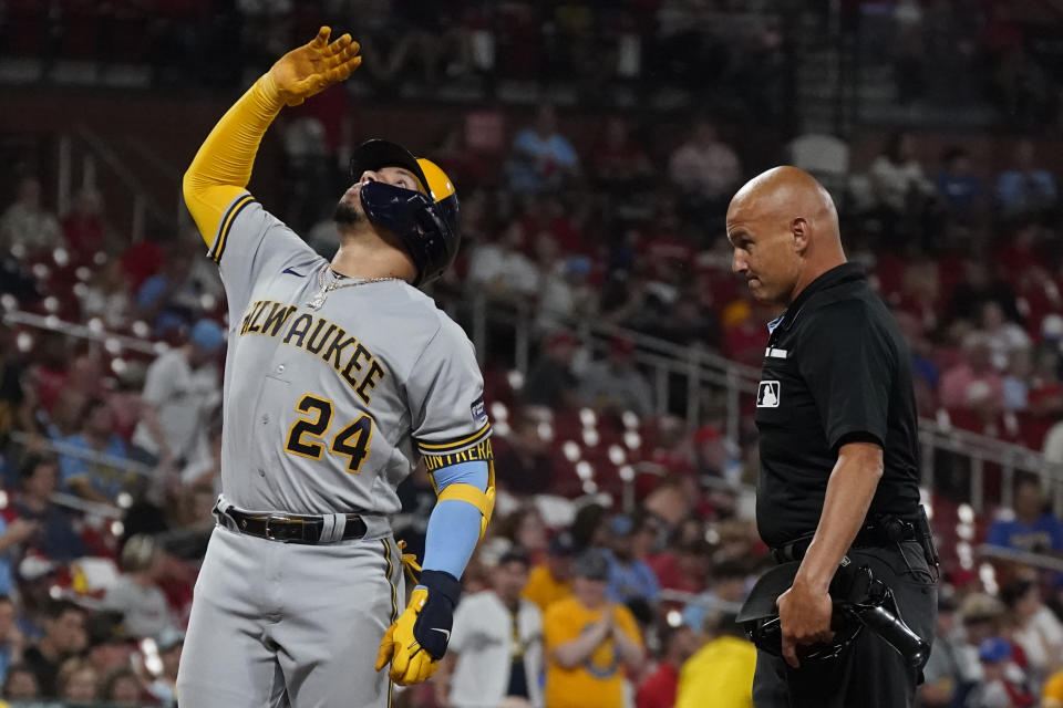 Milwaukee Brewers' William Contreras celebrates after hitting a solo home run as home plate umpire Vic Carapazza, right, watches during the third inning of a baseball game against the St. Louis Cardinals Tuesday, Sept. 19, 2023, in St. Louis. (AP Photo/Jeff Roberson)