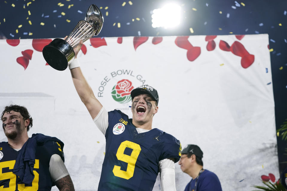 Michigan quarterback J.J. McCarthy (9) celebrates on the podium after a win over Alabama in the Rose Bowl CFP NCAA semifinal college football game Monday, Jan. 1, 2024, in Pasadena, Calif. (AP Photo/Ryan Sun)