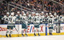 San Jose Sharks celebrate after a goal against the Edmonton Oilers during first-period NHL hockey game action in Edmonton, Alberta, Monday, March 20, 2023. (Jason Franson/The Canadian Press via AP)