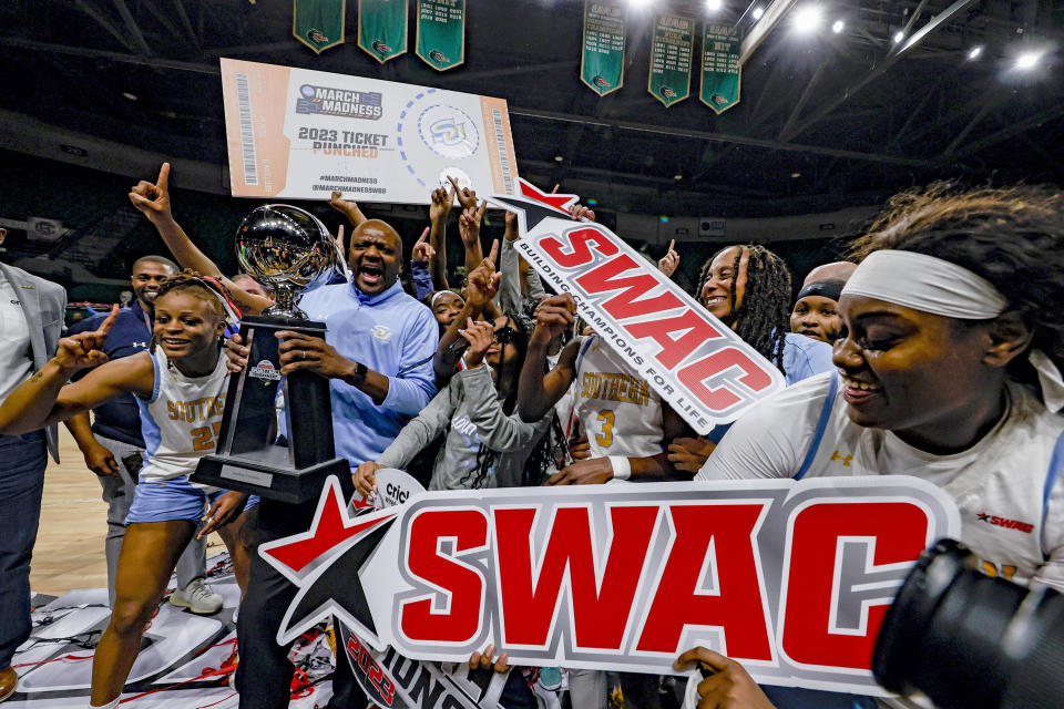 Southern players celebrate after clinching the championship by defeating Arkansas-Pine Bluff after an NCAA college basketball game in the championship of the Southwestern Athletic Conference Tournament, Saturday, March 11, 2023, in Birmingham, Ala. (AP Photo/Butch Dill)