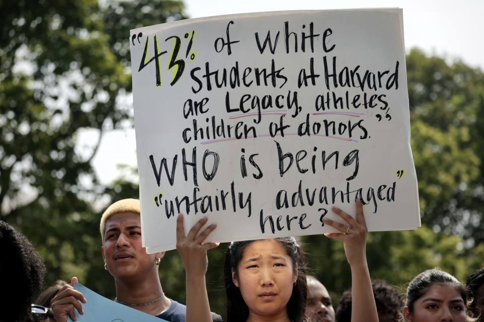 A Harvard student holds a sign during a rally protesting the Supreme Courts ruling against affirmative action