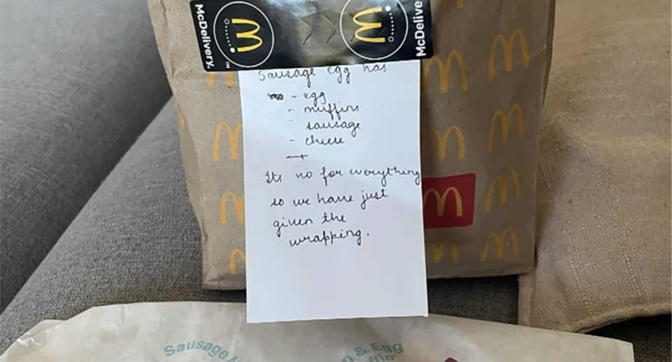 A pregnant McDonald's customer 's empty sausage McMuffin wrapper and note. 