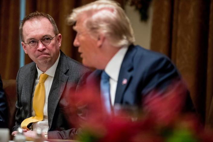 In this Thursday, Dec. 5, 2019, file photo, then-acting chief of staff Mick Mulvaney, left, listens to President Donald Trump, right, speak at a luncheon with members of the United Nations Security Council in the Cabinet Room at the White House in Washington.